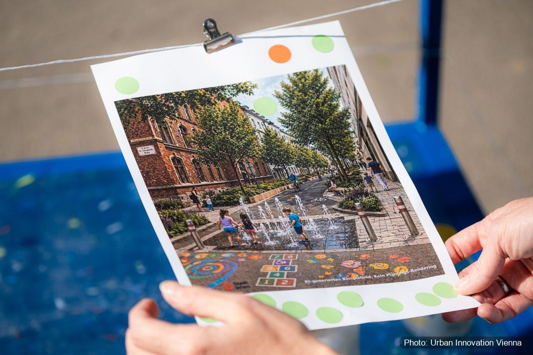 A hand holding a printed scenario, a street with water play and planting, marked with coloured dots.