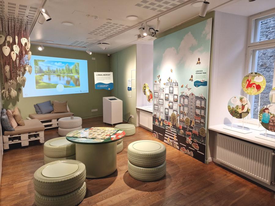 A room with wooden palettes sofas and tyres seating. interactive wall.