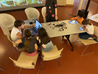 Childrens working on tablets and computer