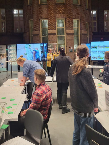 People looking at screens and sitting at a table