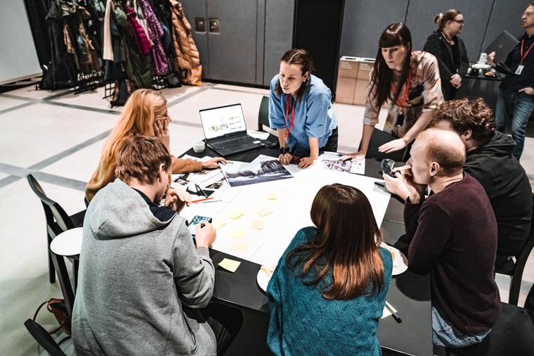 Citizens and planners co-designing around a table in a CoPlanAI workshop