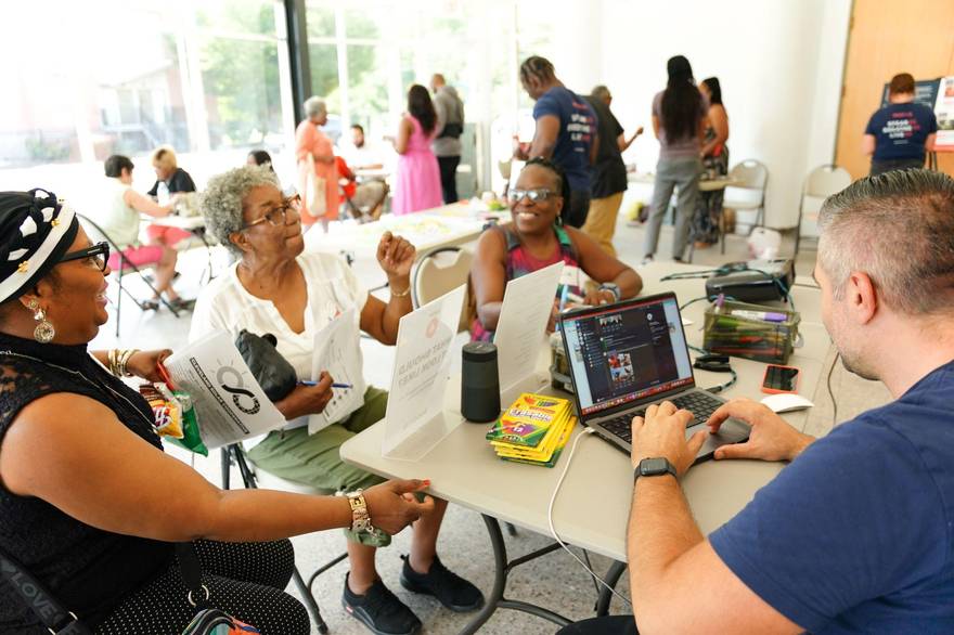 Open-house participants working with tablets in East Cleveland